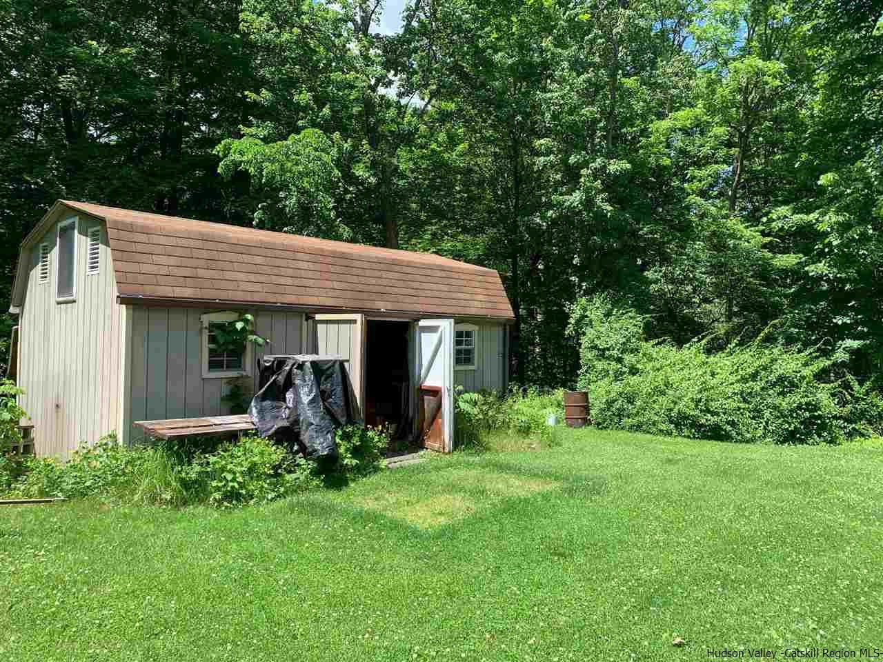 72 Union Center Road Ulster Park, NY 12487 - Photo 10 of 11 a view of a house with a yard potted plants and large tree