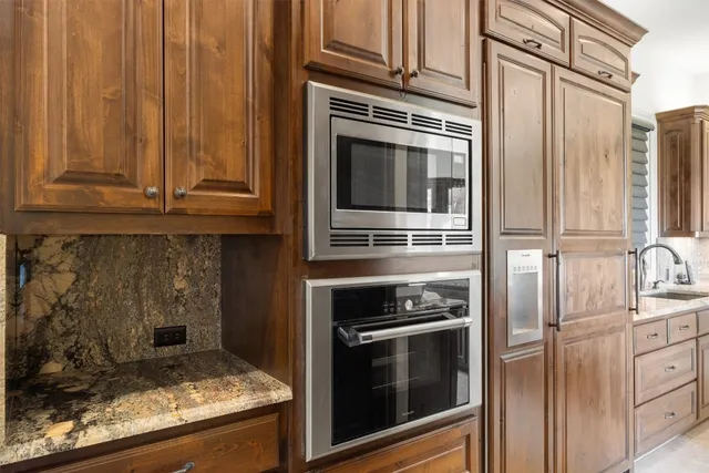 a kitchen with granite countertop a stove and a refrigerator