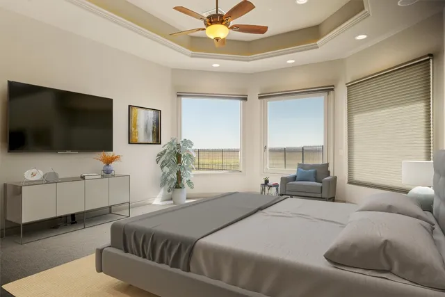 a bedroom with a large bed and a flat screen tv