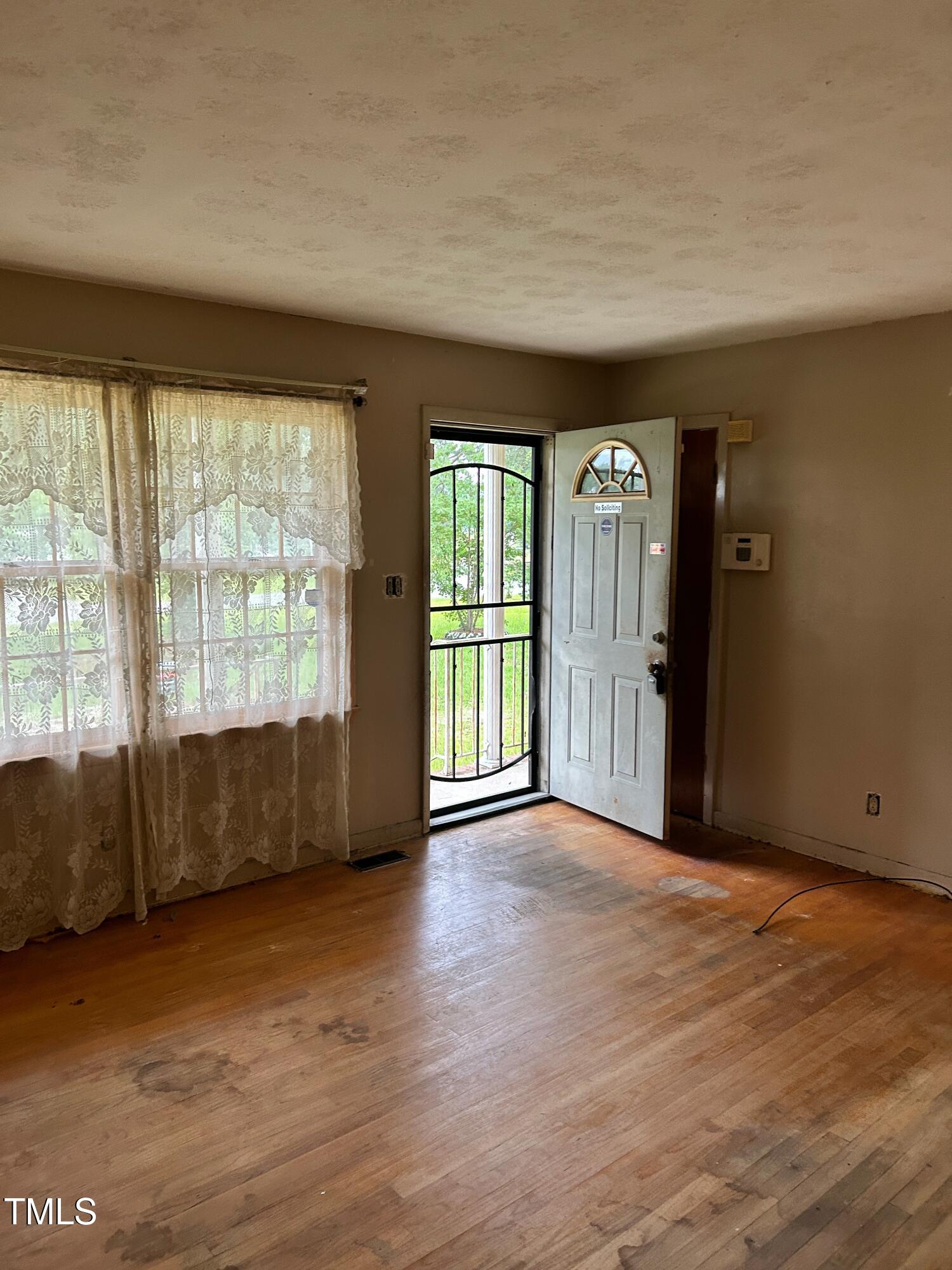 2001 Carr Creek Road Sanford, NC 27332 - Photo 4 of 5 an empty room with wooden floor and windows