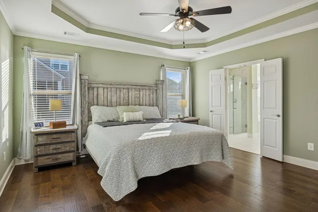 a spacious bedroom with a bed and a chandelier