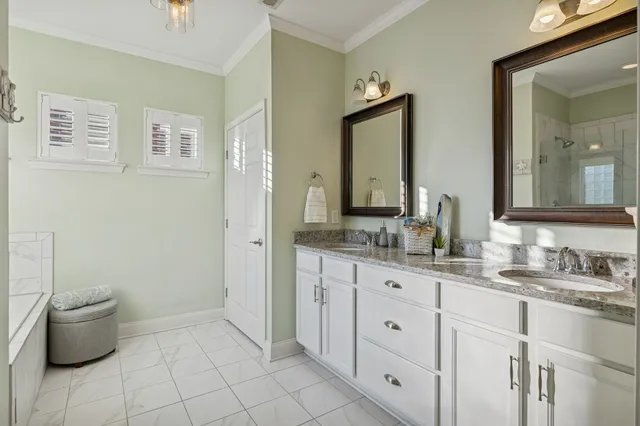a bathroom with a granite countertop toilet sink and mirror