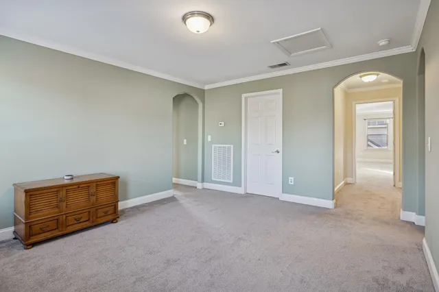 an empty room with windows and closet