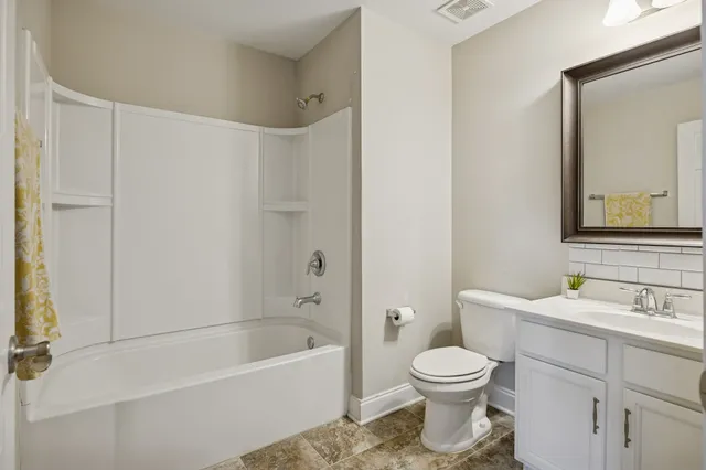 a bathroom with a toilet a sink and a bathtub