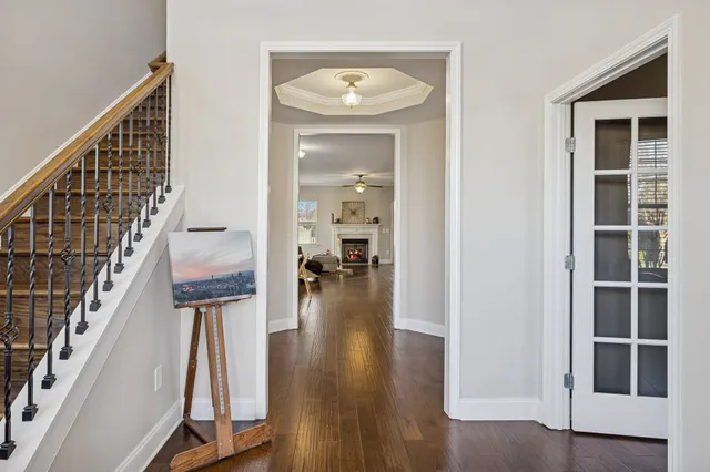 a view of entryway and hall with wooden floor