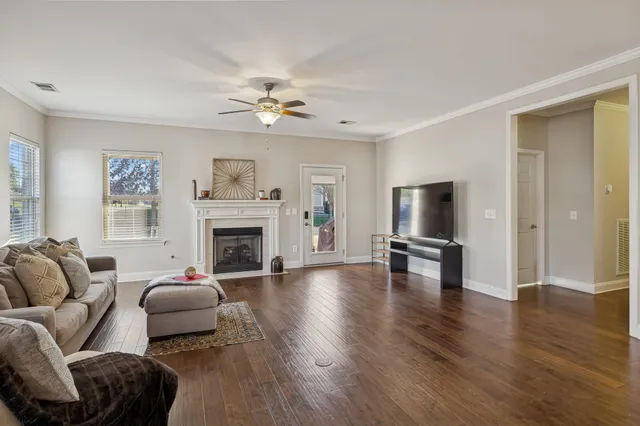 a living room with furniture a fireplace and a flat screen tv