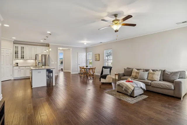 a living room with fireplace furniture and a wooden floor