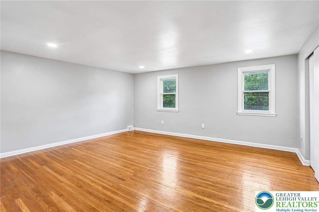 4008 Powell Road Brookhaven, PA 19015 - Photo 21 of 36 Well-lit room featuring rich hardwood flooring and clean, unadorned walls awaiting your personal touch.