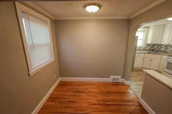 a room with wooden floor and window