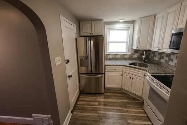 a kitchen with a refrigerator stove and sink