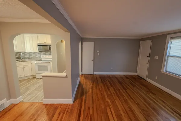 wooden floor in an empty room with a window