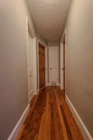 a view of a room with wooden floor