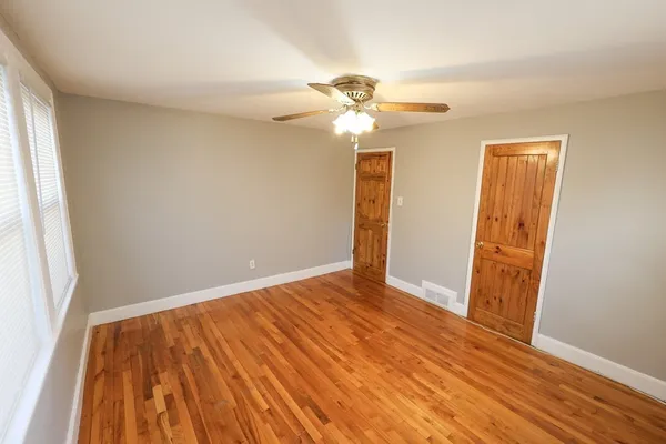 wooden floor in an empty room with a window