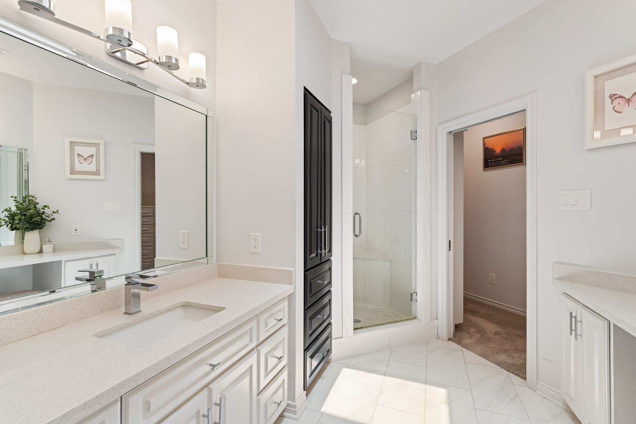 201 Vanderpool Lane, Unit 137 Houston, TX 77024 - Photo 23 of 42 The primary bath continues with a large walk-in shower featuring a glass enclosure and built-in shower bench for a spa-like feel. Marble-look tile floors carry throughout, complemented by a built-in linen/storage cabinet that adds both style and functionality.