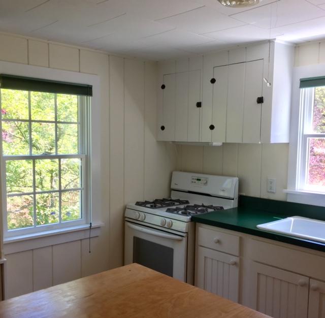 20 Cannon Hill Road Wellfleet, MA 02667 - Photo 8 of 35 a kitchen with granite countertop white cabinets appliances and a window