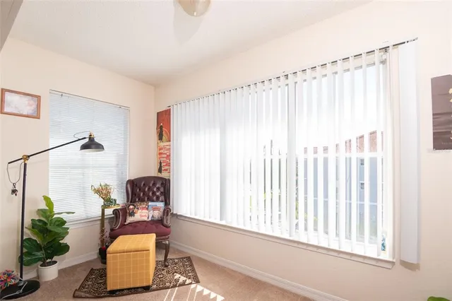 a living room with furniture a flat screen tv and a window