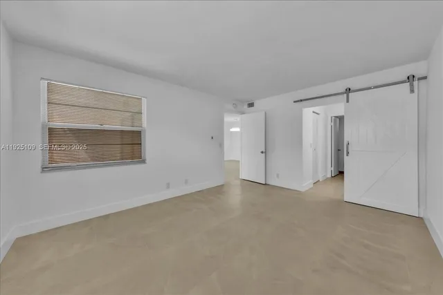 a view of backyard with large trees and flower plants