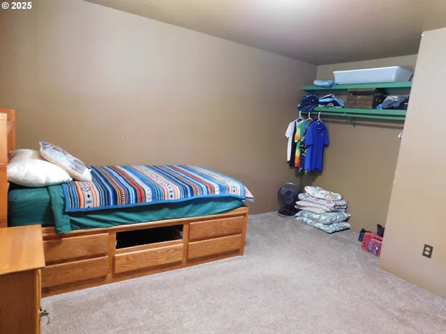 a bedroom with a bed and storage
