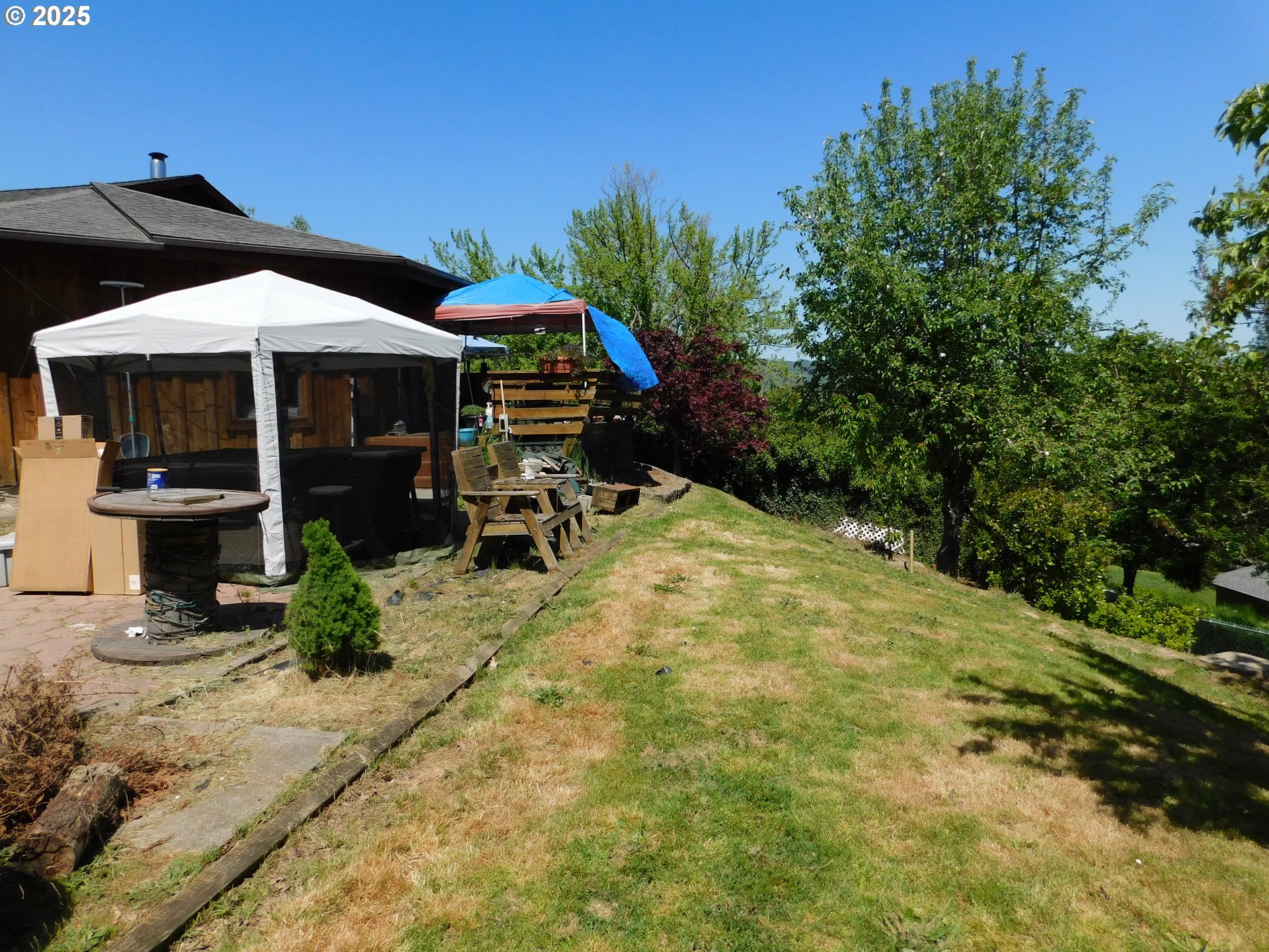 231 Northeast Darrell Avenue Winston, OR 97496 - Photo 43 of 47 a backyard of a house with barbeque oven table and chairs