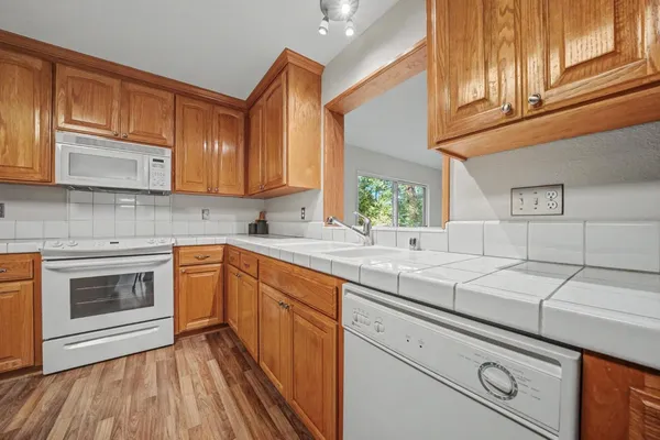 a kitchen with granite countertop a sink stainless steel appliances and cabinets