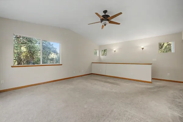 a view of balcony with wooden floor and fence
