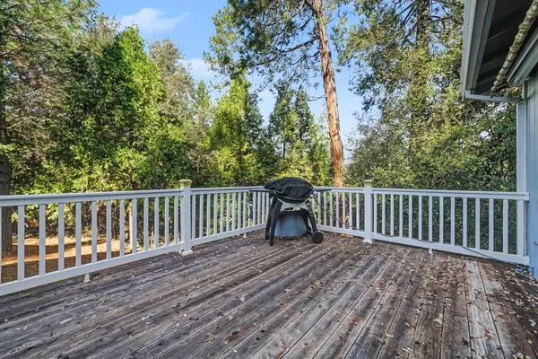 a view of a deck with wooden floor and wooden fence