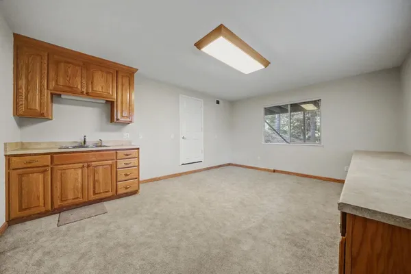 a bedroom with a bed a flat screen tv and a couch