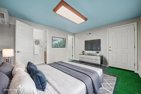 a view of an empty room with window and closet area