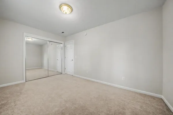 a bedroom with bed and a window