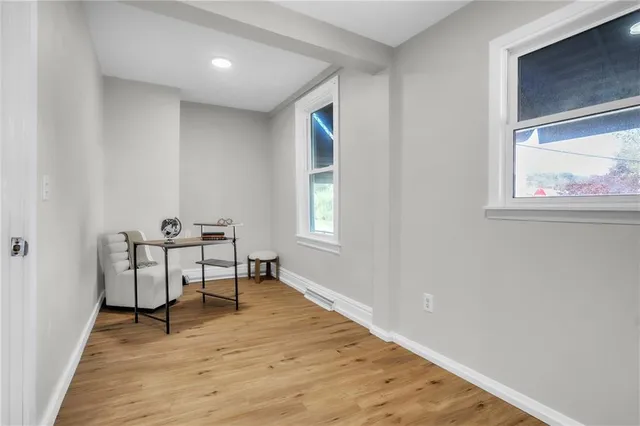 a view of a workspace with furniture and a window