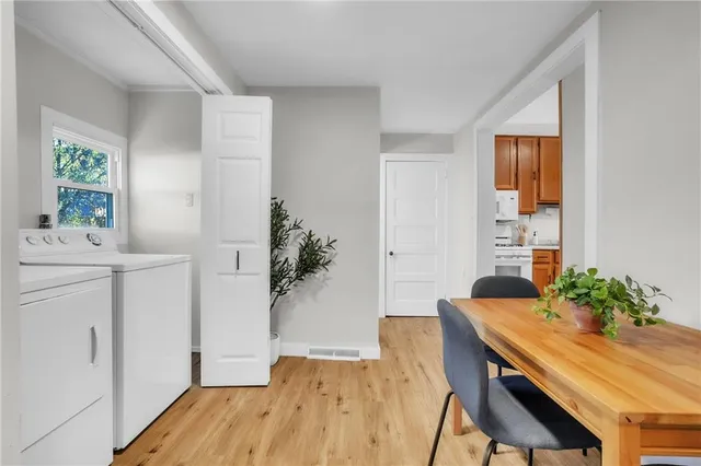 a view of a dining room with furniture window and wooden floor