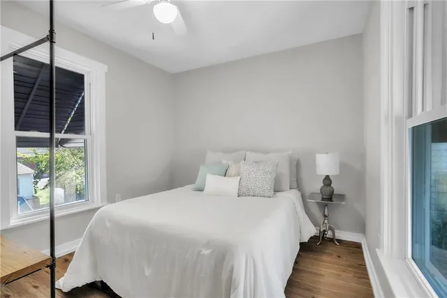 a bedroom with a bed and a large window