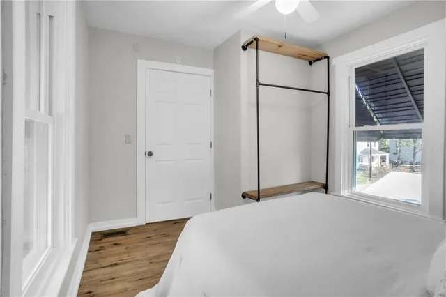 a bedroom with a bed and a window