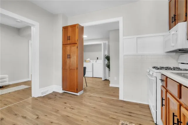 a view of kitchen with stainless steel appliances granite countertop a refrigerator and a stove top oven
