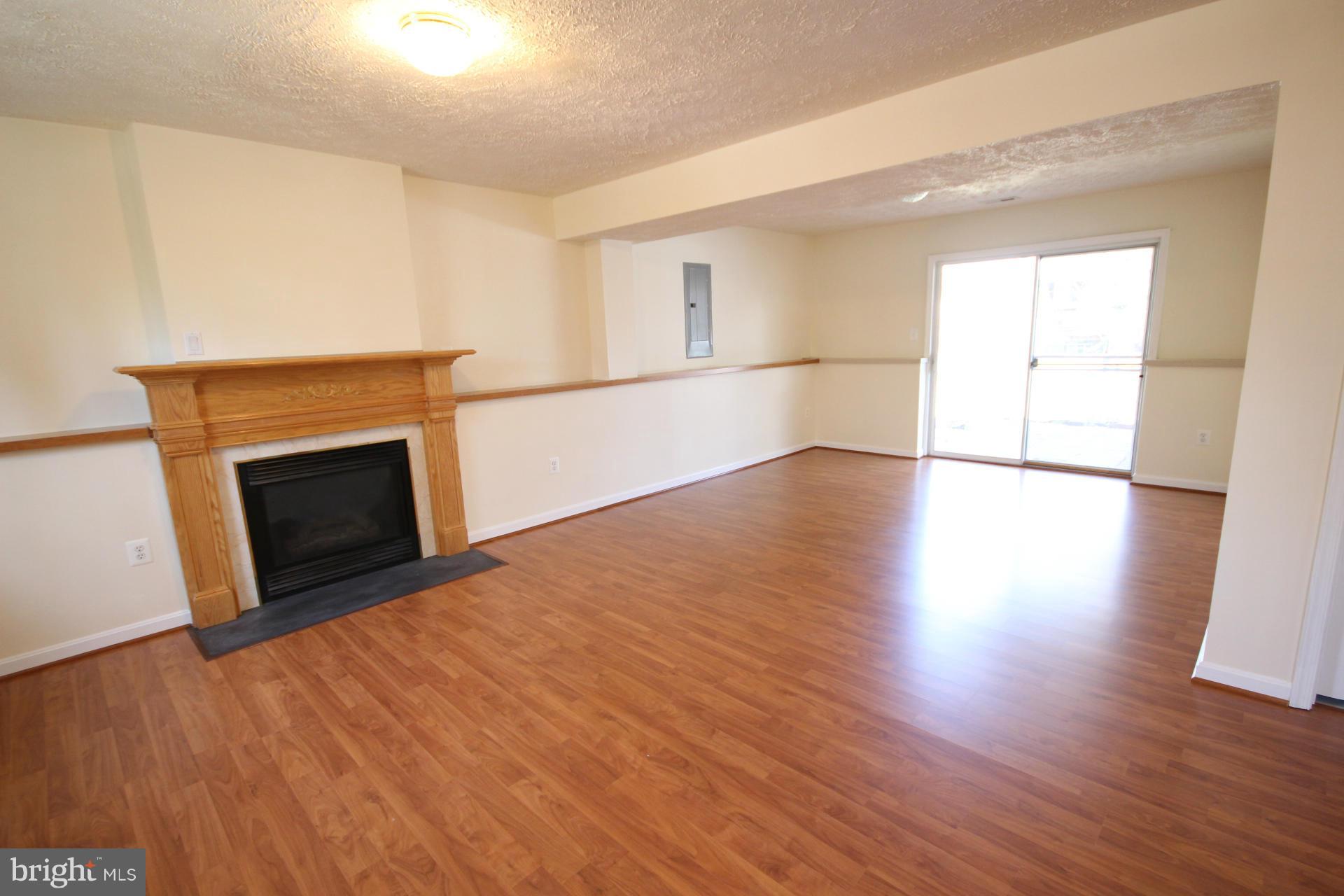 12701 Laux Street Silver Spring, MD 20904 - Photo 14 of 17 Family Room w/gas fireplace & laminate flooring