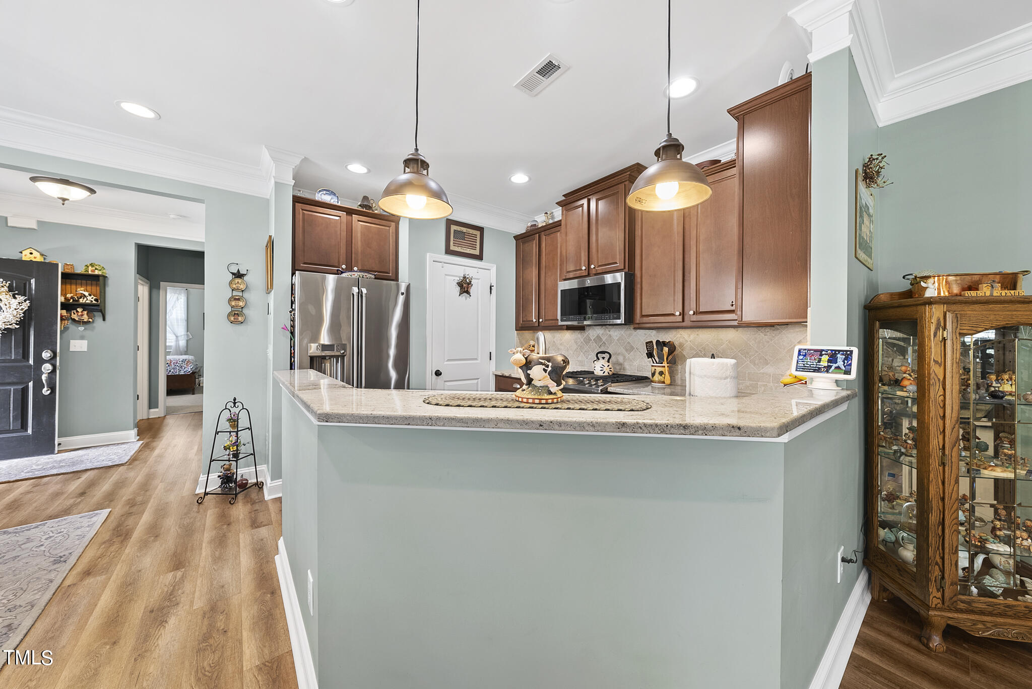 699 Wickham Ridge Road Apex, NC 27539 - Photo 11 of 36 a kitchen with stainless steel appliances granite countertop a sink and a refrigerator