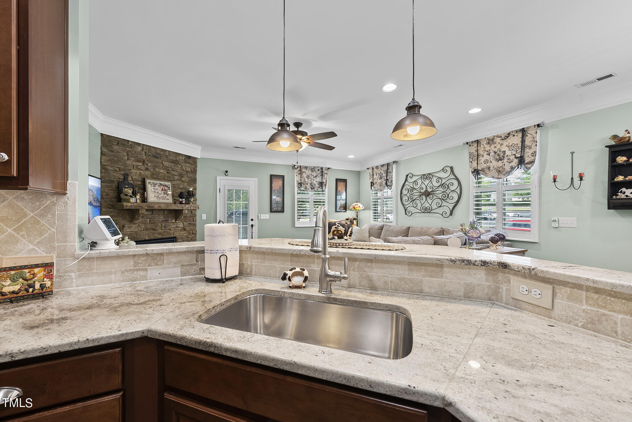 699 Wickham Ridge Road Apex, NC 27539 - Photo 14 of 36 a kitchen with a sink a counter space appliances and cabinets