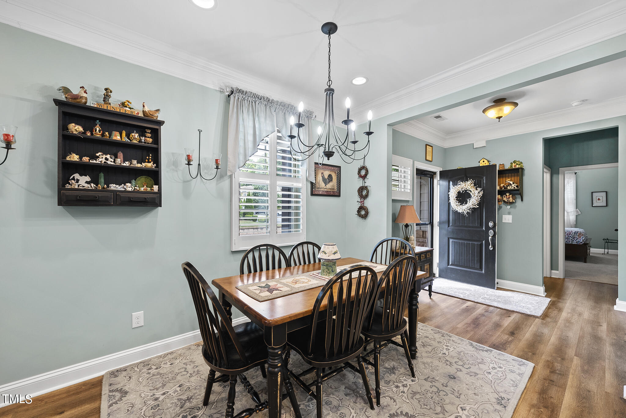 699 Wickham Ridge Road Apex, NC 27539 - Photo 15 of 36 a view of a dining room with furniture and wooden floor