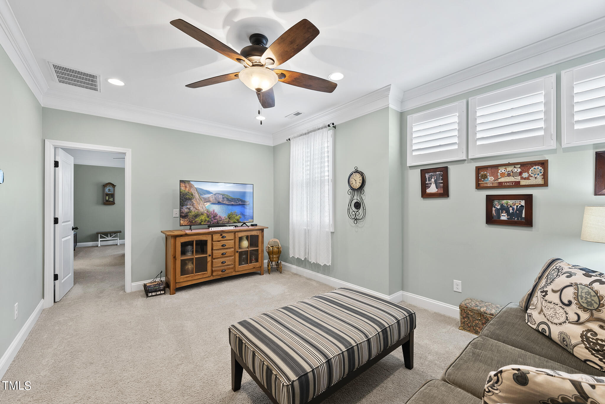699 Wickham Ridge Road Apex, NC 27539 - Photo 19 of 36 a bedroom with a bed and a chandelier