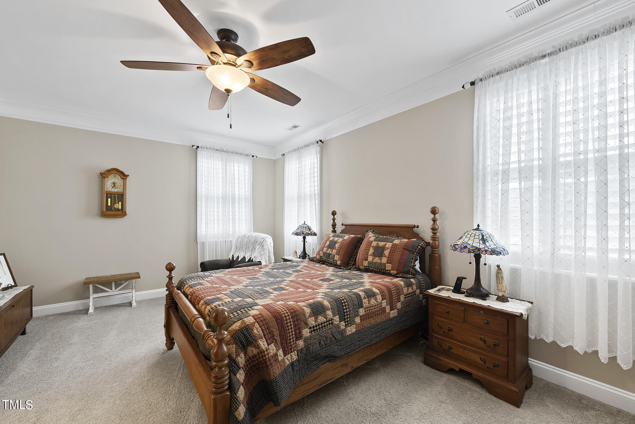 699 Wickham Ridge Road Apex, NC 27539 - Photo 21 of 36 a bedroom with a bed and a chandelier