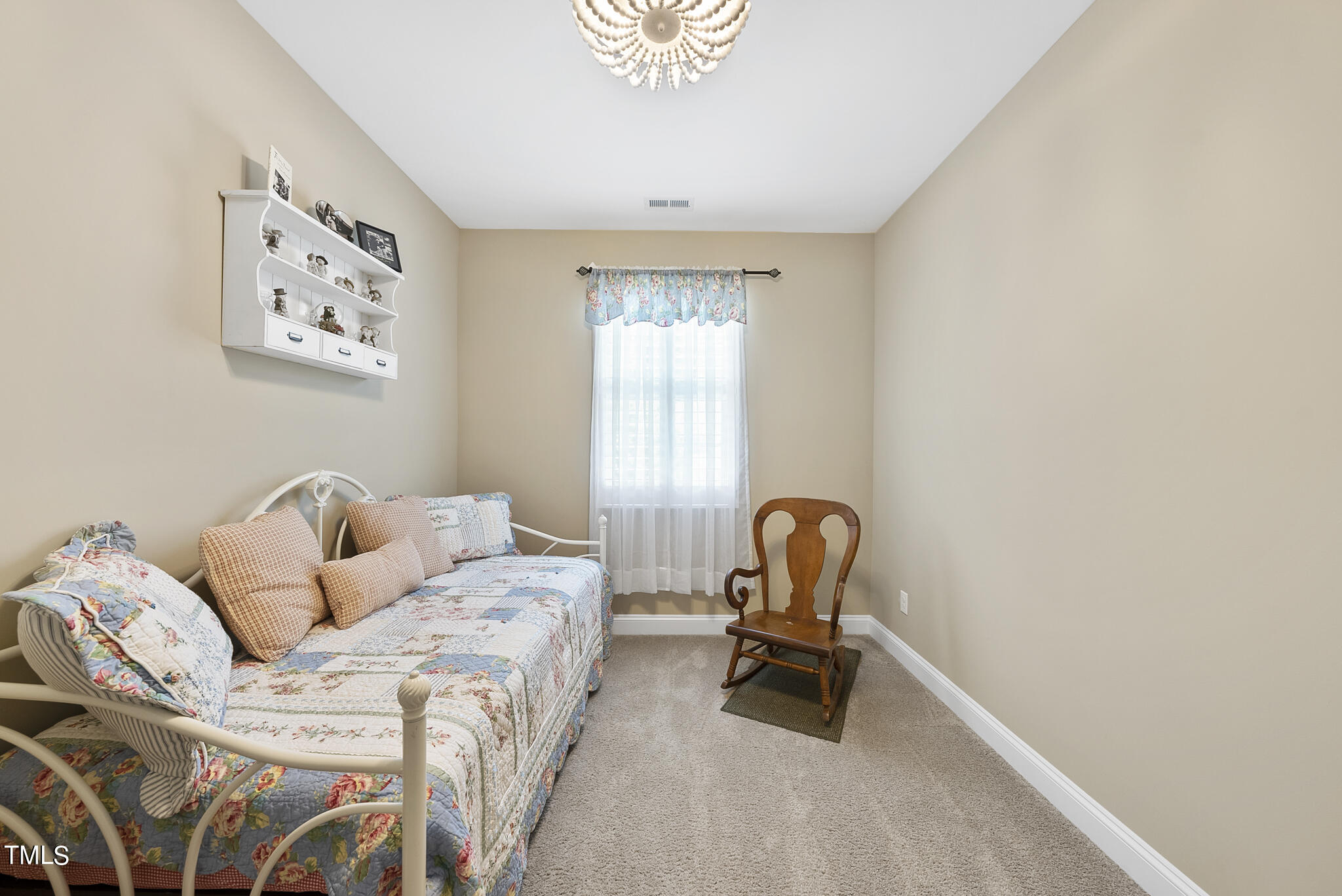 699 Wickham Ridge Road Apex, NC 27539 - Photo 27 of 36 a bedroom with a bed and a chair