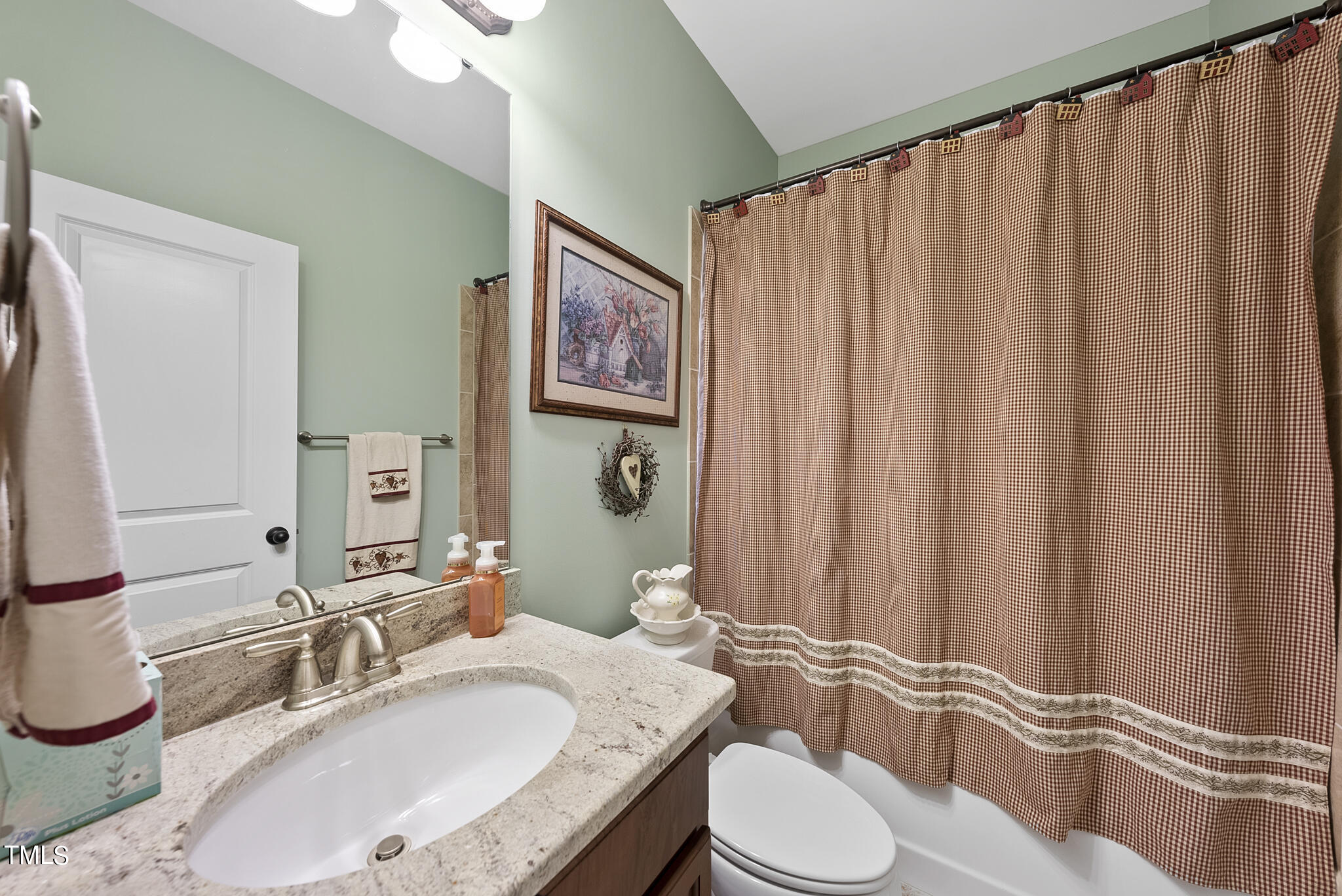 699 Wickham Ridge Road Apex, NC 27539 - Photo 30 of 36 a bathroom with a granite countertop sink and a mirror