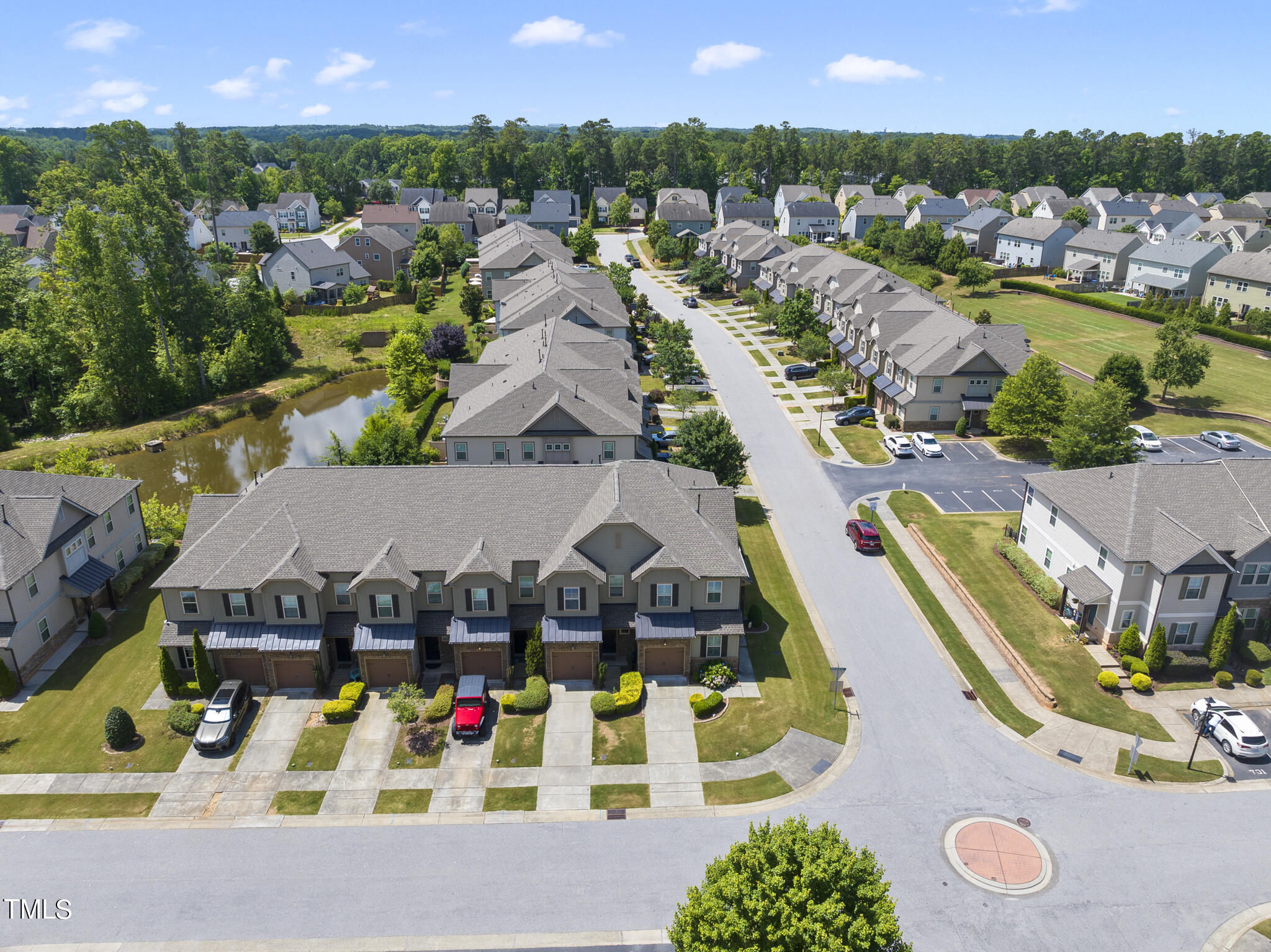 699 Wickham Ridge Road Apex, NC 27539 - Photo 33 of 36 an aerial view of residential houses with outdoor space and parking