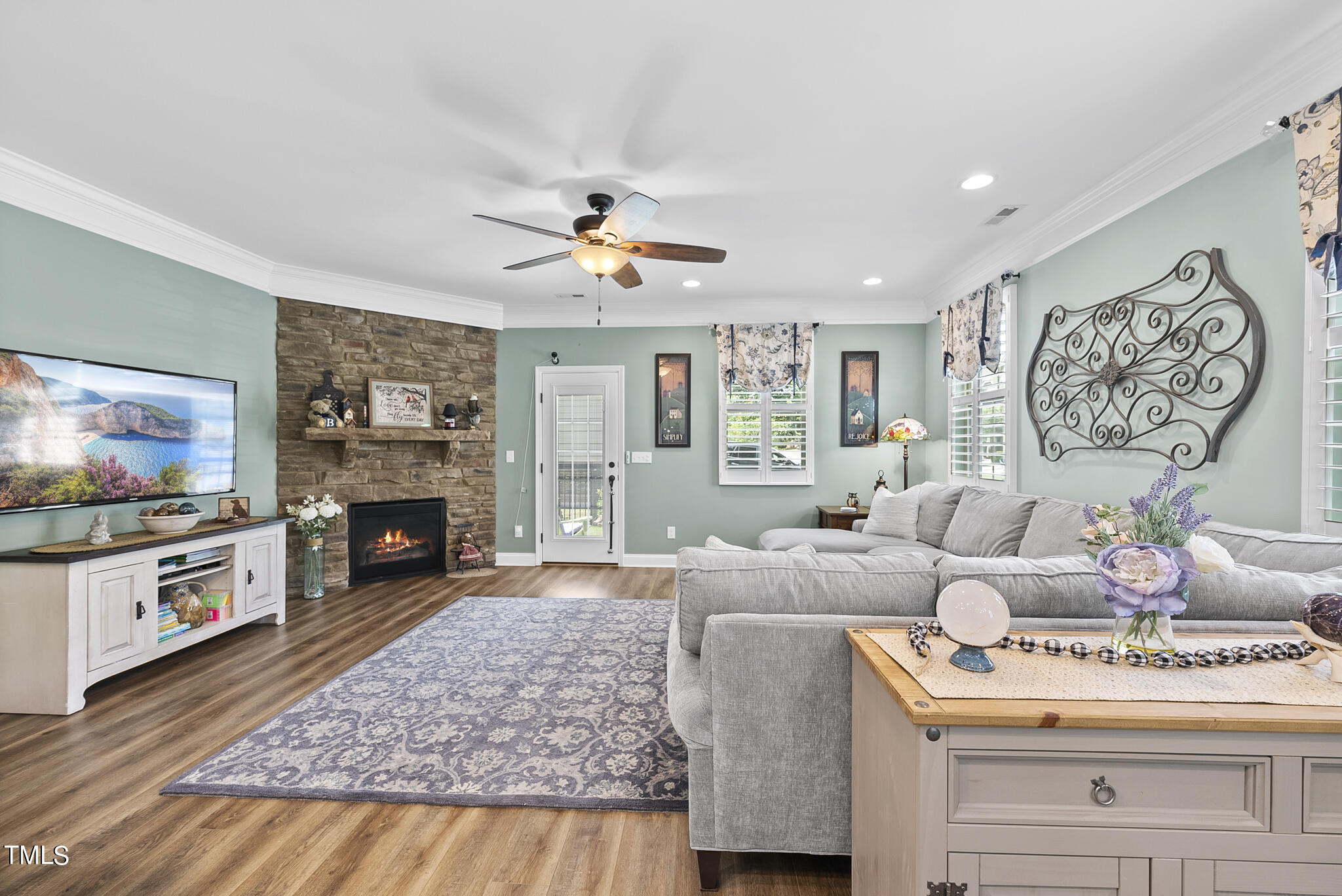 699 Wickham Ridge Road Apex, NC 27539 - Photo 5 of 36 a living room with fireplace furniture and a flat screen tv
