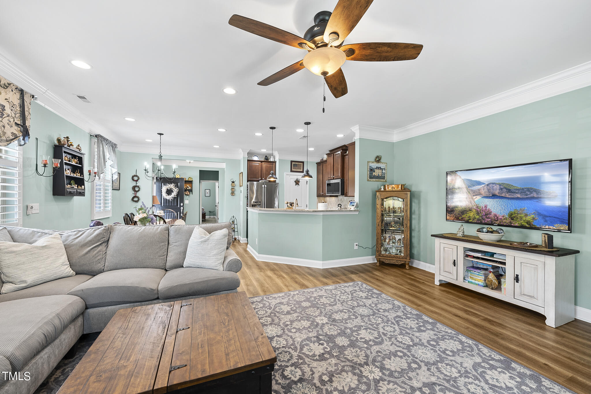 699 Wickham Ridge Road Apex, NC 27539 - Photo 8 of 36 a living room with furniture and a flat screen tv