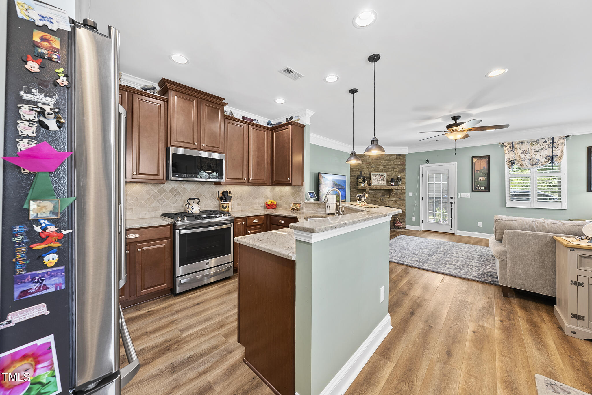 699 Wickham Ridge Road Apex, NC 27539 - Photo 10 of 36 a kitchen that has a lot of cabinets a sink and a stove in it