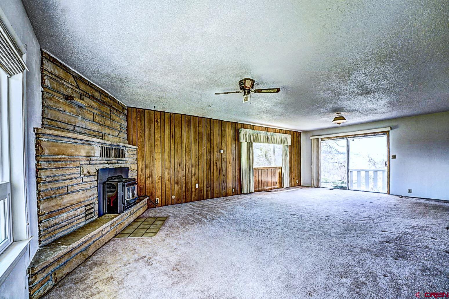 2326 I Road Grand Junction, CO 81505 - Photo 22 of 33 a view of an empty room with a fireplace and a window