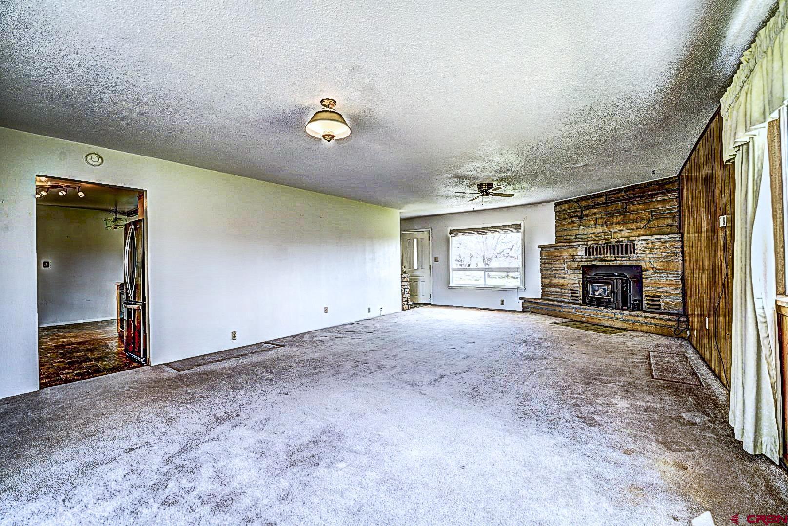 2326 I Road Grand Junction, CO 81505 - Photo 24 of 33 an empty room with windows and fireplace