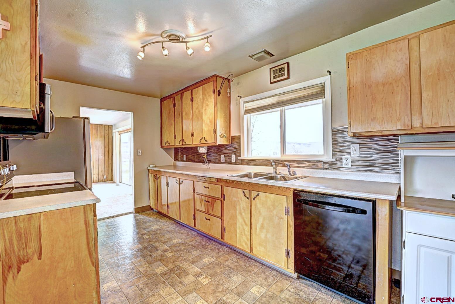 2326 I Road Grand Junction, CO 81505 - Photo 25 of 33 a kitchen with stainless steel appliances granite countertop a stove a sink dishwasher and a refrigerator