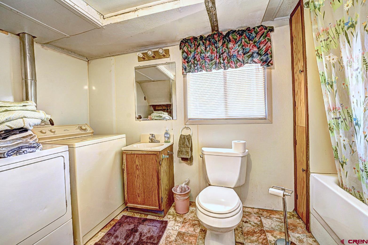 2326 I Road Grand Junction, CO 81505 - Photo 31 of 33 a bathroom with a toilet sink and mirror